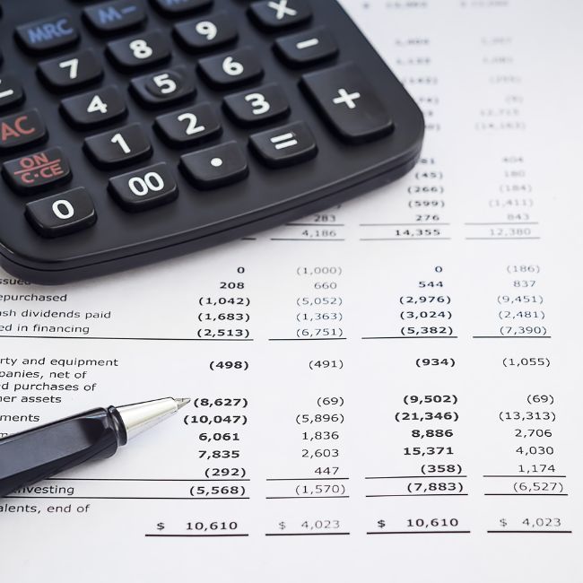 Image of calculator and financial reports which LR Accounting prepares as part of their taxation, business and self-managed superannuation fund support services